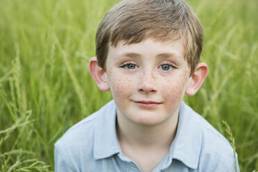 A boy in a blue shirt with brown hair and freckles. - MINF01507