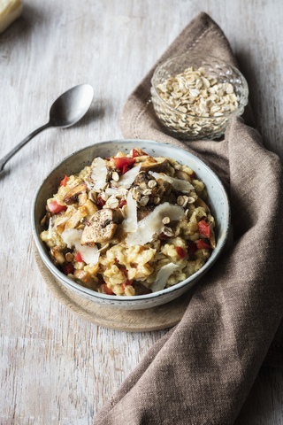 Bowl of porridge with bell pepper, champignon and parmesan stock photo