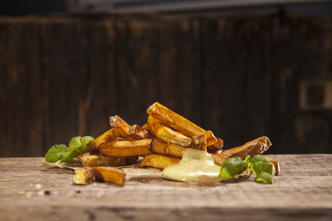 Hand made french fries with mayonnaise on wood stock photo