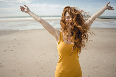 Redheaded woman, laughing happily in the wind - KNSF04214