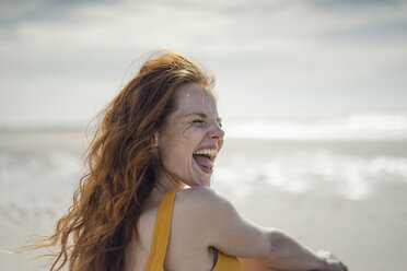Laughing woman having fun on the beach - KNSF04316