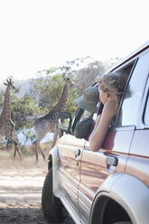 Women looking at giraffes from vehicle, Stellenbosch, South Africa - ISF16999