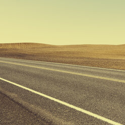 A road through the farming landscape of ploughed fields and farmland near Pullman, Washington state. - MINF02156