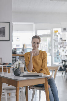 Junge Frau arbeitet in einem Coworking Space und macht eine Pause - JOSF02324