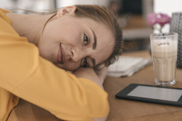 Young woman with digital tablet resting on table in a coffee shop - JOSF02332