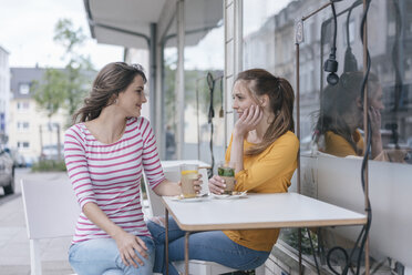 Two girlfriends meeting in a coffee shop, talking - JOSF02340