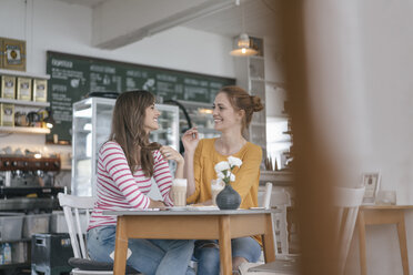 Zwei Freundinnen treffen sich in einem Café und reden - JOSF02383