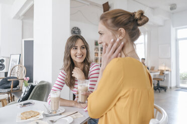 Two girlfriends meeting in a coffee shop, talking - JOSF02385