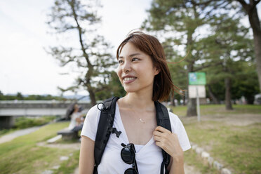 Young woman in the park carrying a rucksack. - MINF02251