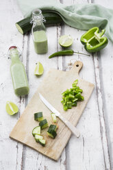 Glass bottle of homemade green Gazpacho and ingredients - LVF07328