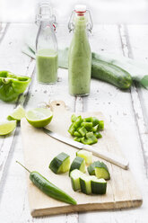 Glass bottle of homemade green Gazpacho and ingredients - LVF07329