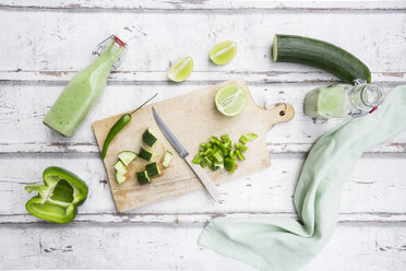 Glass bottles of homemade green Gazpacho and ingredients - LVF07330