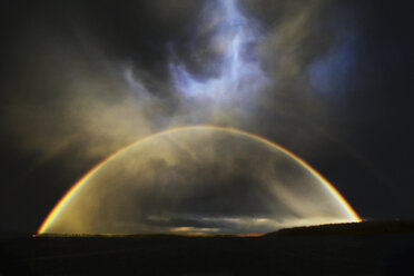 The arc of a rainbow over the landscape. - MINF02354