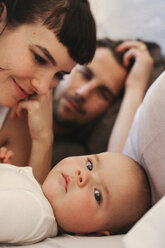 A mother, father and young baby playing at home. - MINF02485