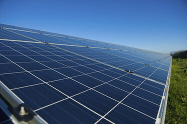 Close up of a row of solar panels in an open field. A solar farm. - MINF02495