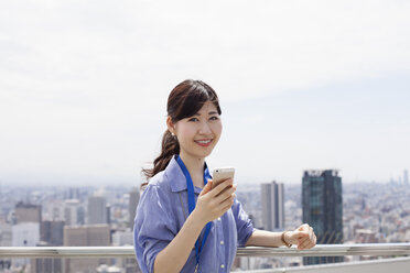 A working woman on a balcony. - MINF02578