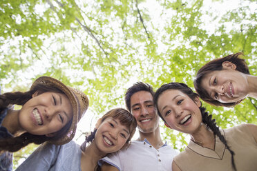 Group of friends at an outdoor party in a forest. - MINF02598