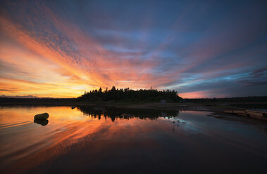 Sunset sky reflected in a lake, and clouds in the sky. - MINF02665