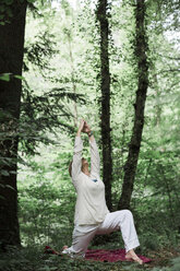 Senior woman doing yoga in the forest - ALBF00589