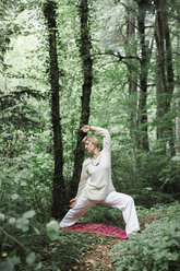 Senior woman doing yoga in the forest - ALBF00591