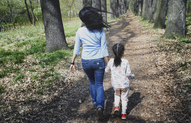 Mother and daughter walking in park, rear view - AZF00015