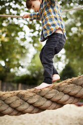 Male toddler crossing rope bridge - ISF17176