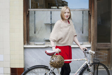 Woman walking bicycle on city street - ISF17198