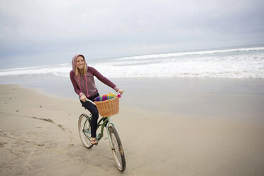 Frau fährt Fahrrad am Strand - ISF17286