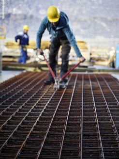 Construction worker cutting iron with plier - CVF00986