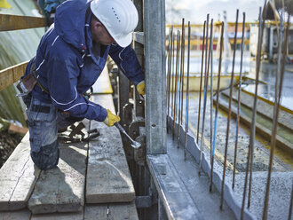 Construction worker working on plywood - CVF00994