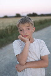 Portrait of blond boy at evening twilight - KMKF00439