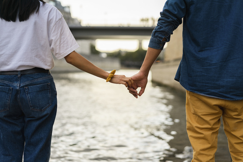 France, Paris, couple holding hands at river Seine stock photo