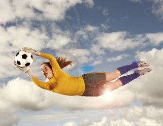 Soccer player catching ball in air - ISF17724