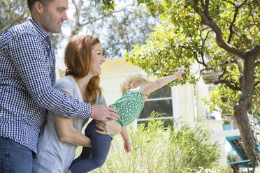 Couple carrying child reaching out - ISF17749