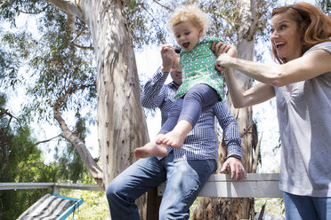 Parents swinging child by the arms - ISF17753