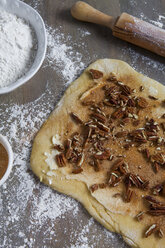 Dough, cinnamon and nuts on board - ISF17781