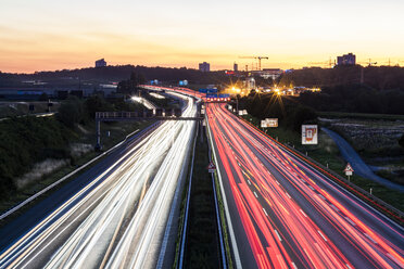 Germany, Baden-Wuerttemberg, Stuttgart, Autobahn A8 in the evening, light trails - WDF04770