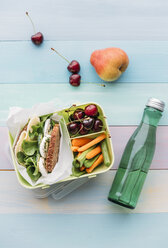 Gesundes Schulessen in der Lunchbox, vegetarisches Sandwich mit Käse, Salat, Gurke, Ei und Kresse, Karotten- und Selleriescheiben, Kirschen und Birne - IPF00464