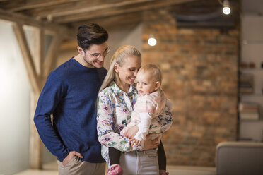 Happy young parents spending time at home with their baby girl - AWF00133