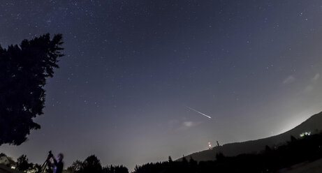 Germany, Hesse, Hochtaunuskreis, Bright Perseid Meteor burning out over Taunus Ranges - THGF00046