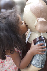 Girl kissing statue outdoors - ISF17856