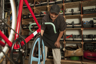 Mechanic working in bicycle shop - ISF17874