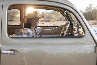 Young woman sitting in car on road trip, portrait - ISF18031