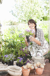 Woman with potted plants in garden - ISF18071