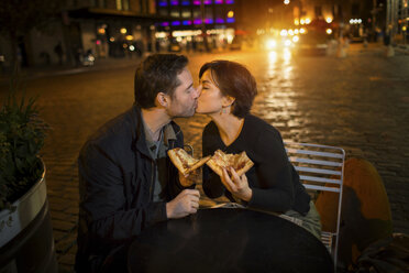Küssendes Paar beim Pizzaessen im Freien - ISF18302