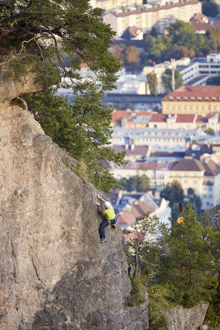 Austria, Innsbruck, Hoettingen quarry, man climbing in rock wall stock photo