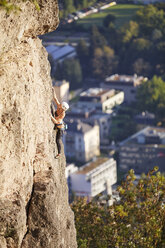 Austria, Innsbruck, Hoettingen quarry, woman climbing in rock wall - CVF01013