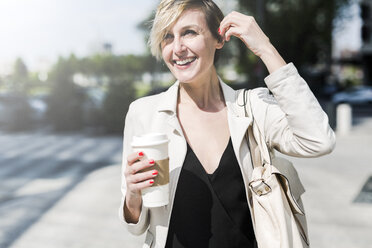 Portrait of laughing businesswoman with Coffee to go - GIOF04022