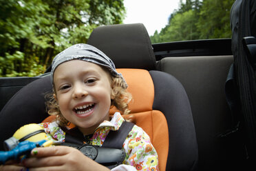 Portrait of female toddler in back seat of open soft top - ISF18591