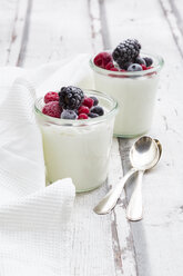 Two glasses of Greek yogurt with frozen berries - LVF07349